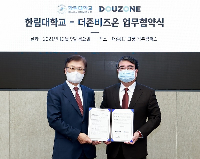 왼쪽부터 최양희 한림대학교 총장과 김용우 더존ICT그룹 회장이 협약서를 교환하고 기념촬영을 하고 있다 (출처: 더존비즈온)