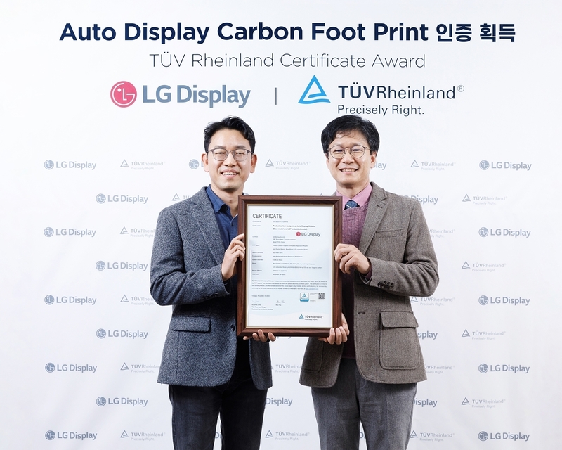 티유브이 라인란드 전기전자 사업부 김종만 이사(오른쪽)가 LG디스플레이 권극상 Auto 제품개발1담당(상무)에게 인증서를 전달하고 있다. (출처 : LG디스플레이)